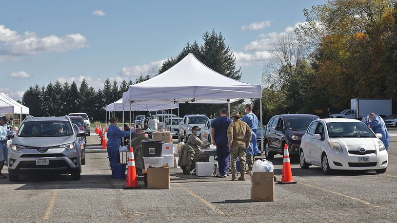 The Clark County Combined Health District holds a free drive-thru COVID-19 testing clinic in the parking lot of Kenton Ridge High School on Oct. 17. BILL LACKEY/STAFF