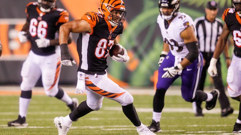 Cincinnati Bengals C.J. Uzomah carries the ball after making a catch during their game against the Baltimore Ravens Thursday, Sept. 13 at Paul Brown Stadium in Cincinnati. The Cincinnati Bengals defeated the Baltimore Ravens 34-23. NICK GRAHAM/STAFF