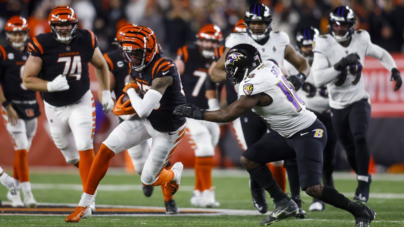 Bengals wide reciver Tee Higgins carries the ball after a catch during Cincinnati's Wild Card playoff game against the Baltimore Ravens Sunday, Jan. 15, 2023 at Paycor Stadium in Cincinnati. The Bengals won 24-17. NICK GRAHAM/STAFF