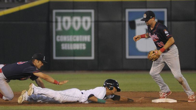 Jose Siri of the Dragons slides safely back to second base after getting caught in a rundown. The Dragons hosted the Peoria Chiefs (Cardinals) at Dayton’s Fifth Third Field in a Class A minor-league baseball game on Wednesday, July 19, 2017. MARC PENDLETON / STAFF