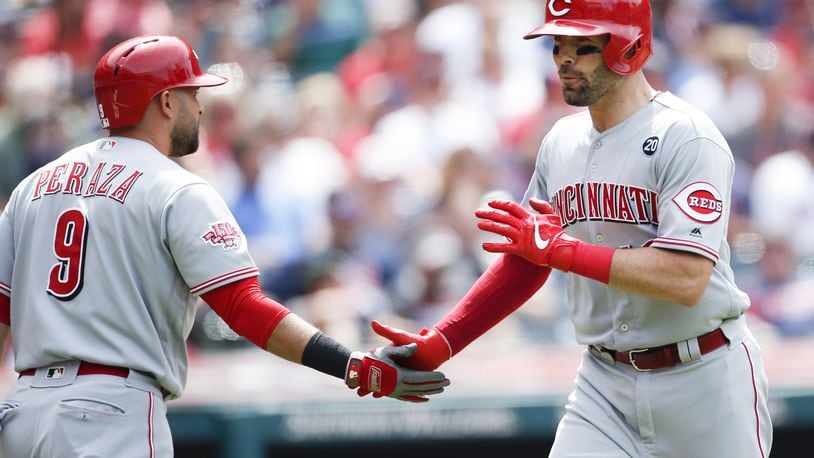 CLEVELAND, OH - JUNE 12: Curt Casali #12 of the Cincinnati Reds celebrates with Jose Peraza #9 after hitting a solo home run off Nick Goody #44 of the Cleveland Indians during the seventh inning at Progressive Field on June 12, 2019 in Cleveland, Ohio. (Photo by Ron Schwane/Getty Images)