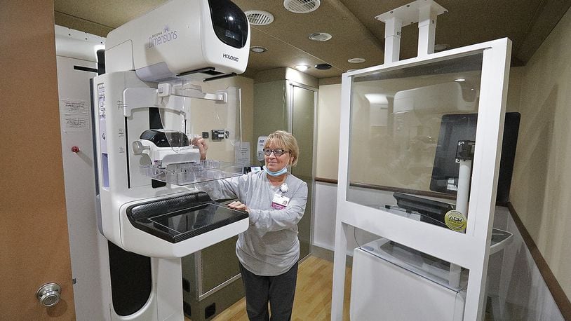 Peggy Gentis gets the machine ready for a patient in the Mercy Health Mobile Mammography Unit. BILL LACKEY/STAFF