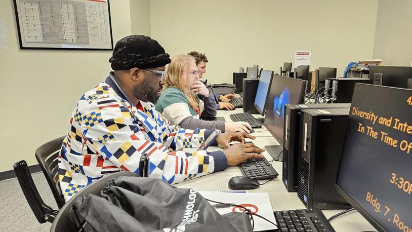 Sinclair Community College computer science students Ayodele Ogunsakin, Spencer McNally, and Louis Jahnigen work on data analysis in the Centerville campus labs. Contributed