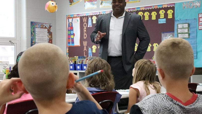 Walter Sledge, the new principal at Snyder Park Elementary, answers questions about himself from students Wednesday on the first day of school. BILL LACKEY/STAFF