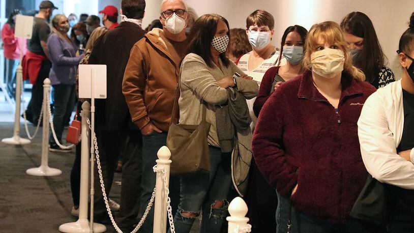 Champaign County Voters wait in line to vote early at the Board of Elections Monday. BILL LACKEY/STAFF