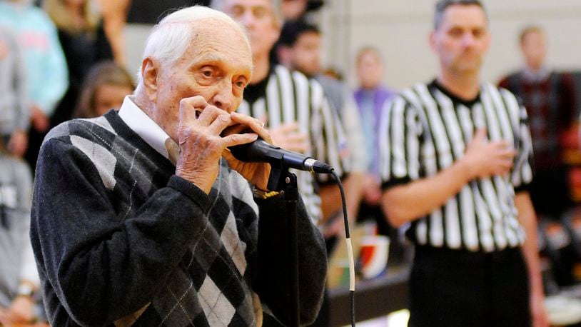 FILE - Former Brooklyn Dodgers baseball player Carl Erskine plays the national anthem on his harmonica before a college basketball game between Anderson and Franlin in Anderson, Ind., Saturday, Jan. 14, 2017. Carl Erskine, who pitched two no-hitters as a mainstay on the Brooklyn Dodgers and was a 20-game winner in 1953 when he struck out a then-record 14 in the World Series, died Tuesday, April 16, 2024, at Community Hospital Anderson in Anderson, Ind., according to Michele Hockwalt, the hospital’s marketing and communication manager. He was 97. (Don Knight/The Herald-Bulletin via AP, File)