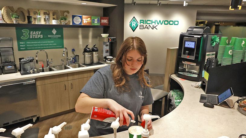 Olivia Henze makes a coffee drink at the Richwood Coffee Shop inside the Richwood Bank at 2454 North Limestone Street Monday, March 13, 2023. BILL LACKEY/STAFF
