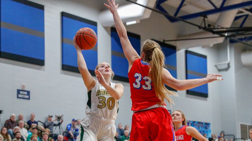 Catholic Central sophomore Serenity Castle shoots the ball over Tri-Village’s Maddie Downing (33) during their district semifinal game on Monday night at Brookville High School. The Patriots won 62-32. CONTRIBUTED PHOTO BY MICHAEL COOPER