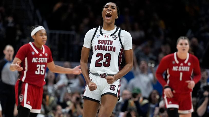 South Carolina guard Bree Hall (23) celebrates after making a three-point basket during the second half of a Final Four college basketball game against North Carolina State in the women's NCAA Tournament, Friday, April 5, 2024, in Cleveland. (AP Photo/Morry Gash)
