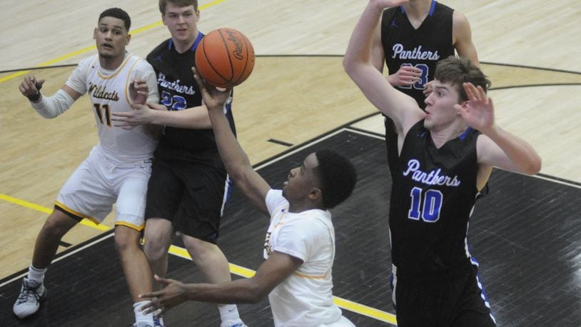 Michael Wallace (with ball) of Springfield avoids Garett Powell of Springboro. Springfield won the D-I sectional semi 77-60 at Centerville on Tuesday, Feb. 27, 20118. MARC PENDLETON / STAFF