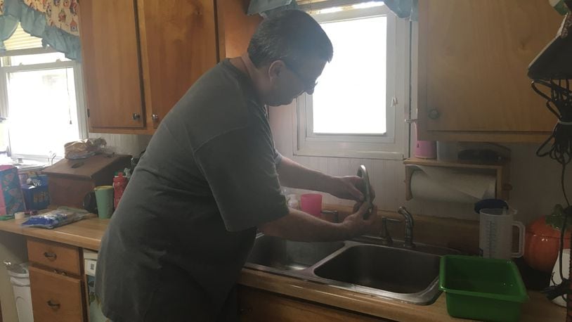 Shawn Campbell turns on the water in his kitchen. His well tested positive for PCE in 2011.