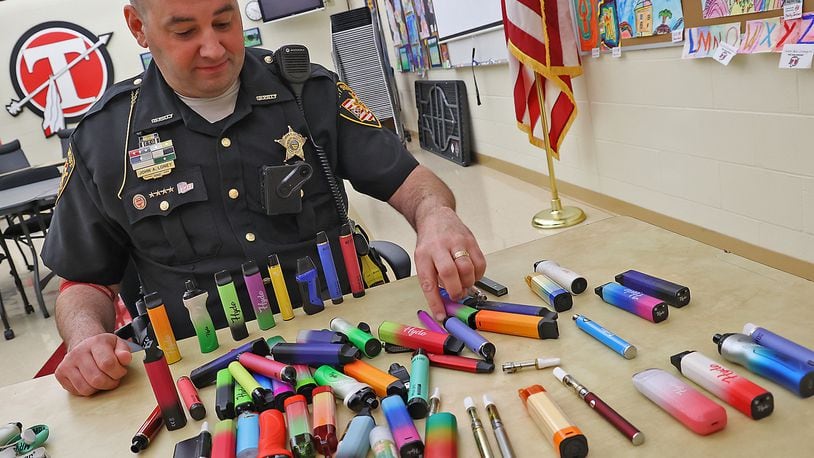 Clark County Sheriff's Deputy John Loney shows some of the recent vaping pens that have been confiscated at Tecumseh High School. Deputy Loney said this is the second batch of confiscated pens he's collected at the school. BILL LACKEY/STAFF