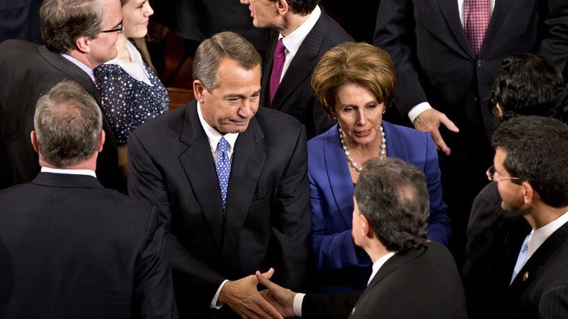 House Speaker John Boehner of Ohio enters the House of Representatives chamber on Capitol Hill in Washington, Thursday, Jan. 3, 2013, after surviving a roll call vote in the newly convened 113th Congress. He is escorted by House Majority Leader Eric Cantor of Va., and House Minority Leader Nancy Pelosi of Calif. (AP Photo/J. Scott Applewhite)