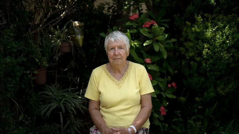 Judith Tzamir, a Holocaust survivor from Germany, poses for a portrait in her family home in Kibbutz Meflasim, southern Israel, Friday, May 3, 2024. On Monday, Tzamir will join 55 other Holocaust survivors from Israel and around the world for a memorial march in Poland, called March of the Living. (AP Photo/Maya Alleruzzo)