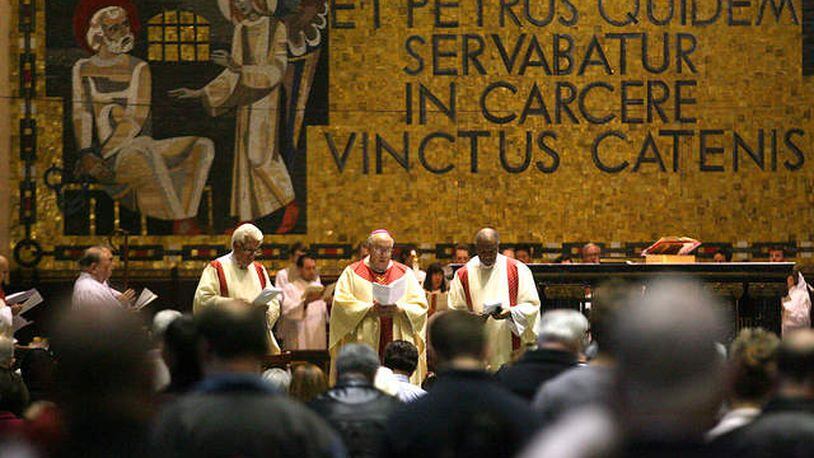 A Roman Catholic Mass is celebrated at St. Peter in Chains Cathedral in downtown Cincinnati to celebrate the election of Pope Francis in a 2013 file photo. Behind the altar, a mosaic in Latin says “Et Petrus quidem servabatur in carcere vinctus catenis,” which translates, “And Peter was kept in prison, bound in chains.” CONTRIBUTED