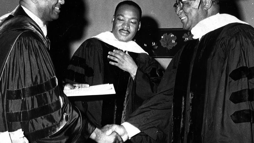 Dr. Martin Luther King Jr. (center) watches as his father Dr. Martin Luther King Sr. (right) received an honorary Doctor of Humanities degree from Dr. Rembert S. Stokes, president of Wilberforce University June 9, 1965. DAYTON DAILY NEWS ARCHIVE