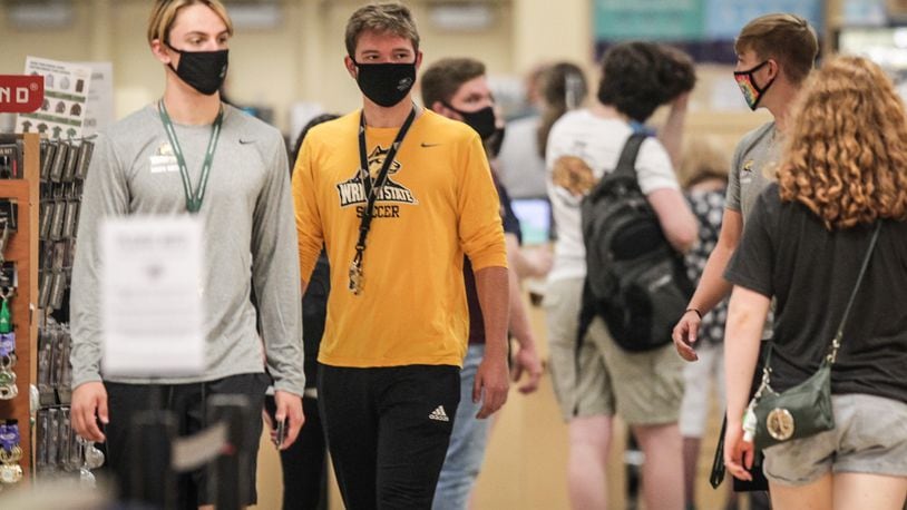 Wright State University student, in limited numbers, returned to class Monday August 24, 2020. There were students lined up in the bookstore practicing social distancing and almost all students were wearing masks. JIM NOELKER/Staff