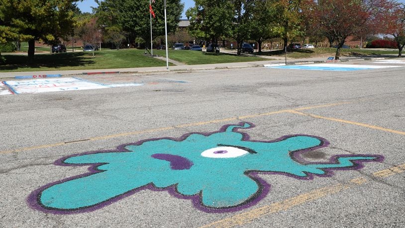 A student's parking spot painting seems a little ironic in the empty parking lot of Kenton Ridge. The school had an outbreak of COVID-19 cases and went to online learning for two weeks. Northeastern schools will now use hybrid learning through next week due to Clark County coronavirus alert level. BILL LACKEY/STAFF