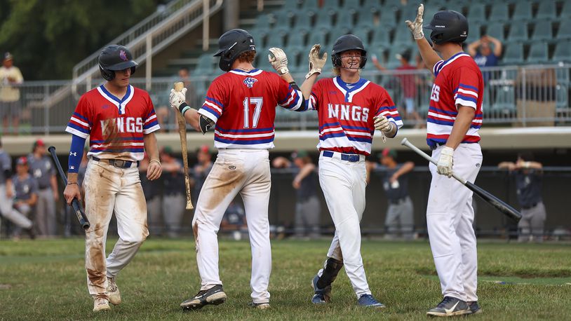 Cutline: Champion City Kings infielder Ben Ross (second from right) celebrates with teammates after scoring during their 13-5 victory over the Danville Dans on Wednesday, July 28. Ross recently set the Kings record for hits in a season. CONTRIBUTED PHOTO BY MICHAEL COOPER