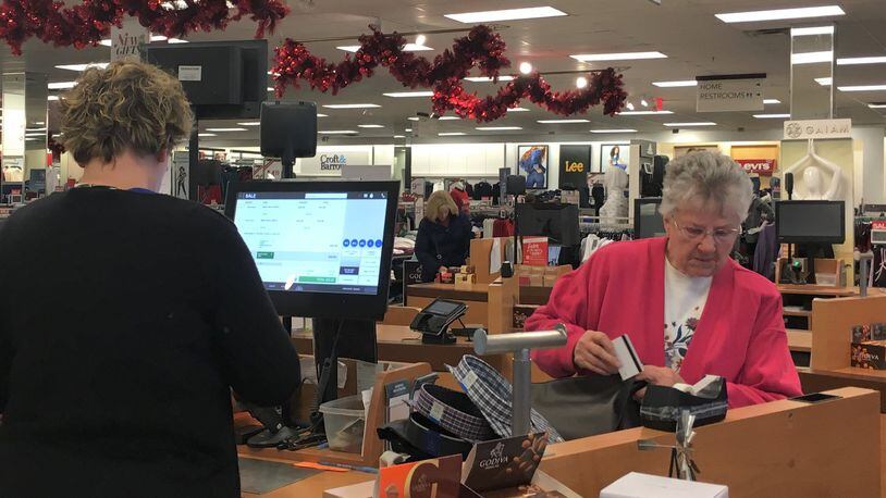 Holiday shoppers are already hitting store as the “Super Bowl” retail week approaches. Ruth Hildebrecht checks out at the Centerville Kohl’s. STAFF PHOTO / HOLLY SHIVELY