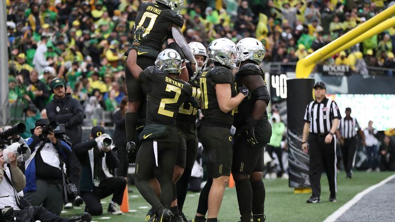Oregon running back Bucky Irving (0) celebrates with teammates after scoring a touchdown against California during the second half of an NCAA football game, Saturday, Nov. 4, 2023, in Eugene, Ore. (AP Photo/Amanda Loman)