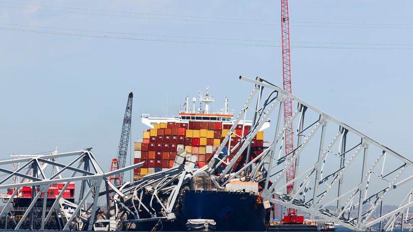 The collapsed Francis Scott Key Bridge lay on top of the container ship Dali, Monday, April 15, 2024, in Baltimore. The FBI confirmed that agents were aboard the Dali conducting court-authorized law enforcement activity. (AP Photo/Julia Nikhinson)