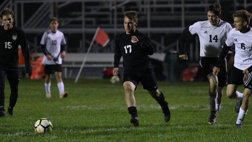 Greenon High School sophomore Trent Green dribbles the ball through several Preble Shawnee defenders during the Knights 9-0 victory over Preble Shawnee on Monday, Oct. 15. Green leads the team with 21 goals this season. Michael Cooper/CONTRIBUTED