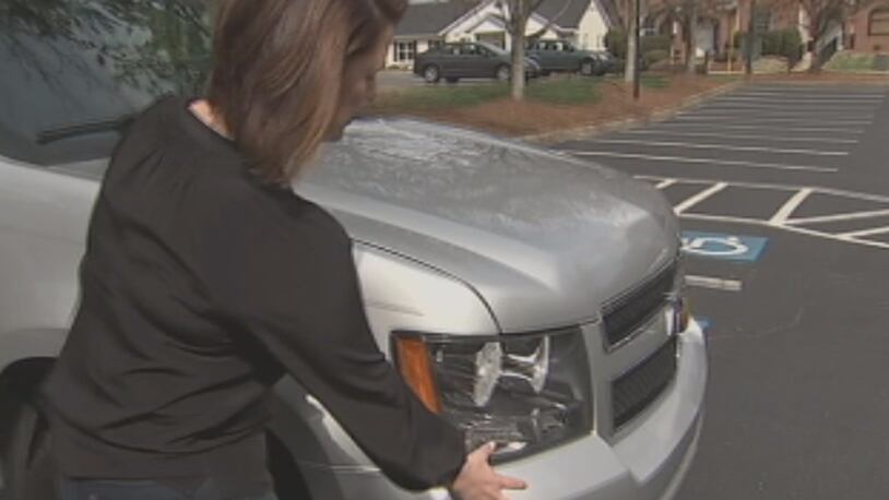 Summer Cline shows where her vehicle was damaged after a crash that wasn't her fault.