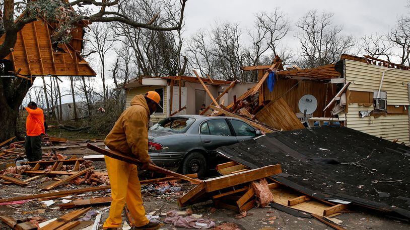 Harry Hobbs, left, takes a break from cleaning up the remnants of the house he is renting from Kelvin Magnum, right, after a storm ripped it apart Tuesday, Feb. 14, 2017, in Van Vleck, Texas. Tornadoes are suspected of damaging homes and knocking out power southwest of Houston as part of a strong storm system that moved quickly across much of the state.