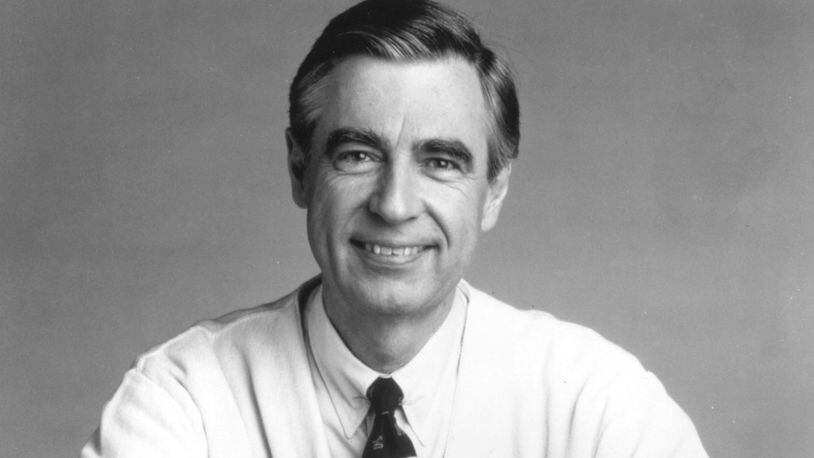 FILE PHOTO: Fred Rogers, the host of the children's television series, "Mister Rogers' Neighborhood," rests his arms on a small trolley in this promotional portrait from the 1980's.