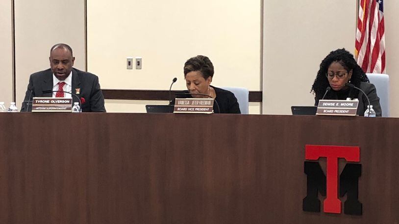 From left, Superintendent Tyrone Olverson and school board members Vanessa Jeter-Freeman and Denise Moore review the agenda at the Dec. 6, 2018 Trotwood-Madison school board meeting.