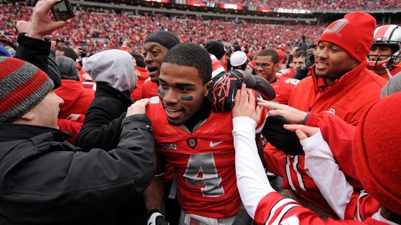 COLUMBUS, OH - NOVEMBER 24:  C.J. Barnett #4 of the Ohio State Buckeyes is congratulated by fans after Ohio State defeated the Michigan Wolverines 26-21 at Ohio Stadium on November 24, 2012 in Columbus, Ohio.  (Photo by Jamie Sabau/Getty Images)