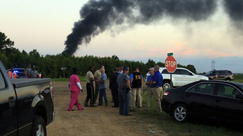 Emergency officials respond to the site of a military plane crash near Itta Bena, Miss., Monday, July 10, 2017. Leflore County Emergency Management Agency Director Frank Randle told reporters at a late briefing that more than a dozen bodies had been recovered after the KC-130 spiraled into the ground about 85 miles (135 kilometers) north of Jackson in the Mississippi Delta. (Elijah Baylis/The Clarion-Ledger via AP)