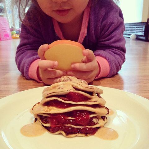 Most unappetizing photo of my peanut butter and jelly pancakes for #nationalpancakeday BUT the cutest thing is when my daughter pretends to take photos of our food with a piece of play toast!