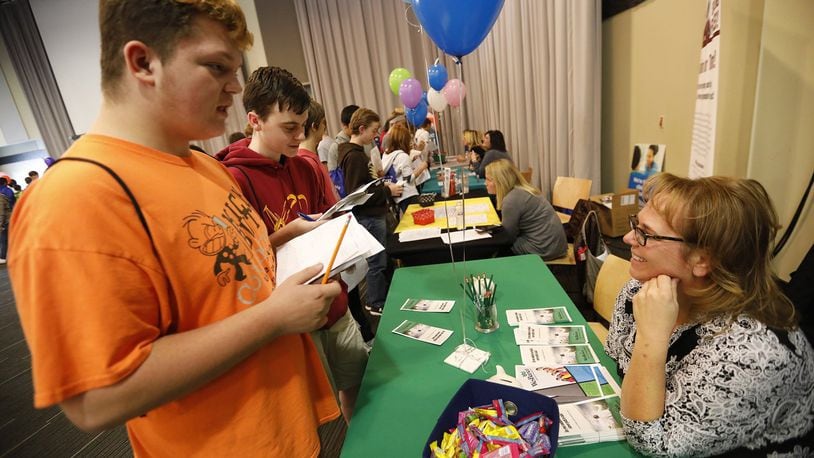 Dylan Verkler, left, and Jaden Koster, both from South Vienna Middle School, talk to C. Lenee Landry, from WesBanco, Wednesday during the Clark County 8th Grade Job Fair at Clark State. Bill Lackey/Staff