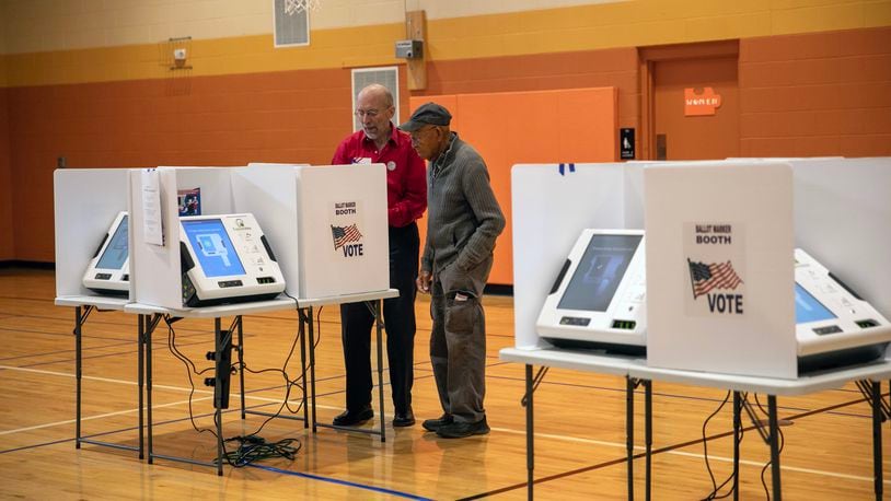 
                        A poll worker, left, assists a voter at a polling place set up inside the Driving Park Community Center in Columbus, Ohio, on Election Day, Nov. 7, 2023. Voters headed to the polls in several states on Tuesday as this off-year election culminates with some key races on the line for Democrats and Republicans. (Maddie McGarvey/The New York Times)
                      