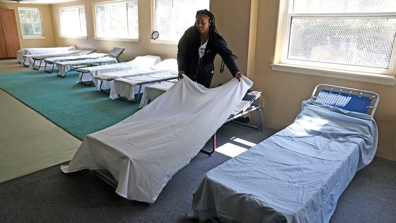 Taylor Cobb makes the beds Tuesday, Sept. 5, 2023 as she helps get Norm's Place homeless shelter ready to reopen. BILL LACKEY/STAFF