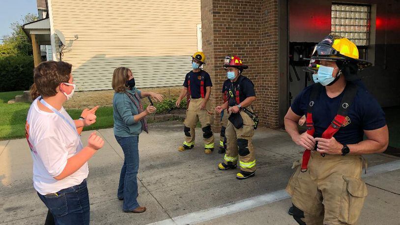 Noah Chesshir, left, and Beth Dixon rehearse with firefighters from Springfield's Station 8 prior to shooting a TikTok video for First Responder Appreciation Week in Springfield. Photo by Brett Turner