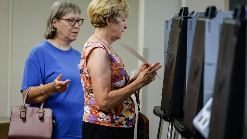 Debbie Miller, left and Rosie Miller cast their early ballot at the Montgomery County Board of Elections Tuesday July 11, 2023, JIM NOELKER/STAFF