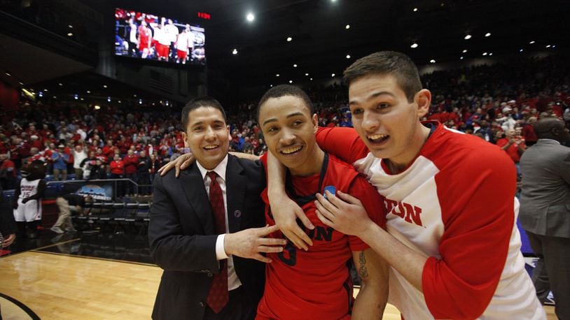 Dayton assistant coach Tom Ostrom, Kyle Davis and Nick Haldes celebrate after a victory against Boise State in the First Four on Wednesday, March 18, 2015, at UD Arena. David Jablonski/Staff