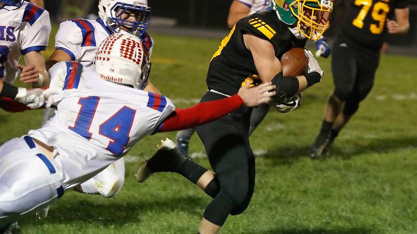 Greeneview’s Caden Anderson dives as he tries to tackle Madison-Plains’ Conner Jones during a Week 10 game. The Rams lost to CHCA on Friday night in the first round of the Division V, Region 20 playoffs. Bill Lackey/Staff