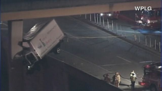 Truck dangles off Miami freeway