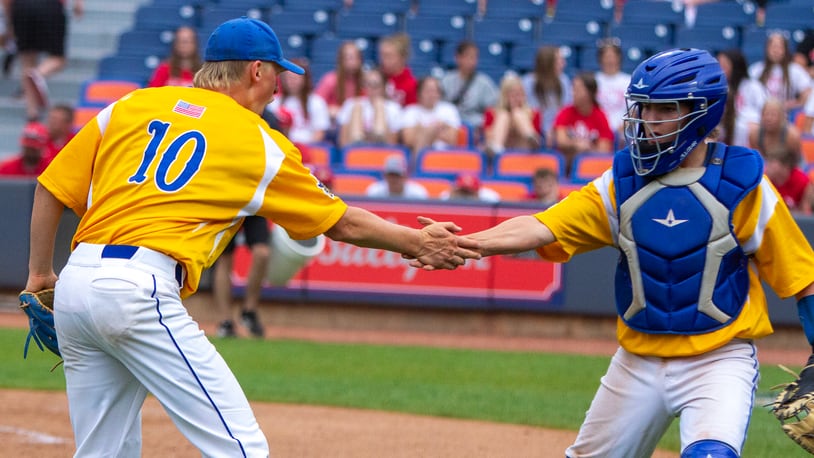 Russia pitcher Xavier Phlipot and catcher Cooper Unverferth celebrate getting out of a jam in the sixth inning of their 1-0 victory in eight innings over St. Henry in the Division IV semifinals at Canal Park in Akron. Jeff Gilbert/CONTRIBUTED