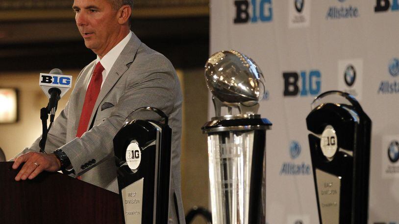 Ohio State coach Urban Meyer addresses the media with the Big Ten championship trophies next to him at Big Ten Football Media Days at the Hilton in Chicago on Monday, July 28, 2014. David Jablonski/Staff
