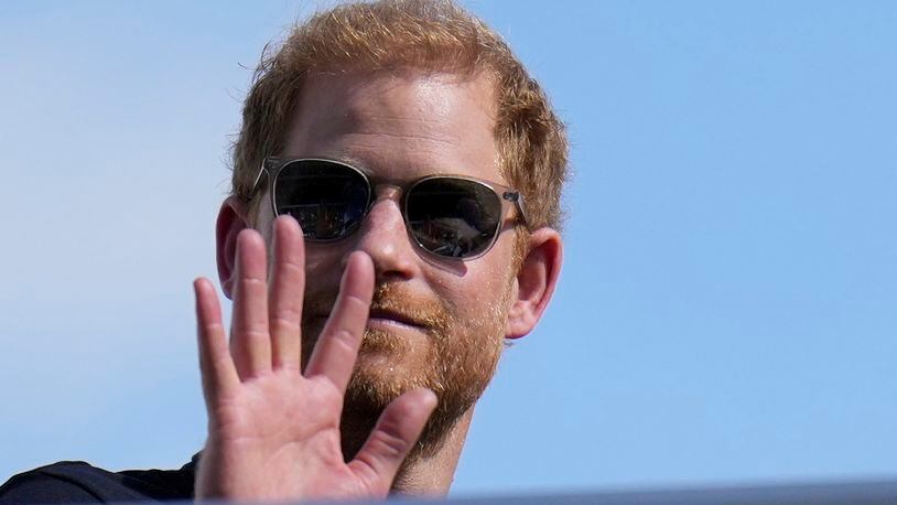 FILE - Britain's Prince Harry, the Duke of Sussex, waves during the Formula One U.S. Grand Prix auto race at Circuit of the Americas, on Oct. 22, 2023, in Austin, Texas. Prince Harry arrived in London on Tuesday May 7, 2024 to mark the 10th anniversary of the Invictus Games but won’t see his father during the visit, a spokesperson said. (AP Photo/Nick Didlick, File)