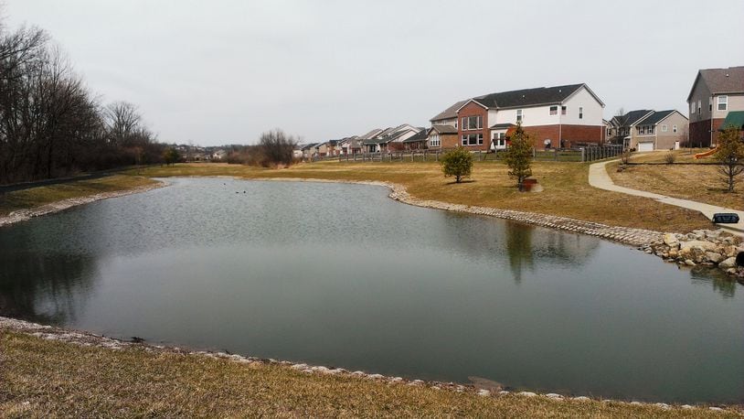 A 9-month-old girl was rescued from this retention pond after her stroller rolled into the water on Windy Harbor Way in West Chester Twp. on Monday, March 31, 2014. ERIC SCHWARTZBERG/STAFF