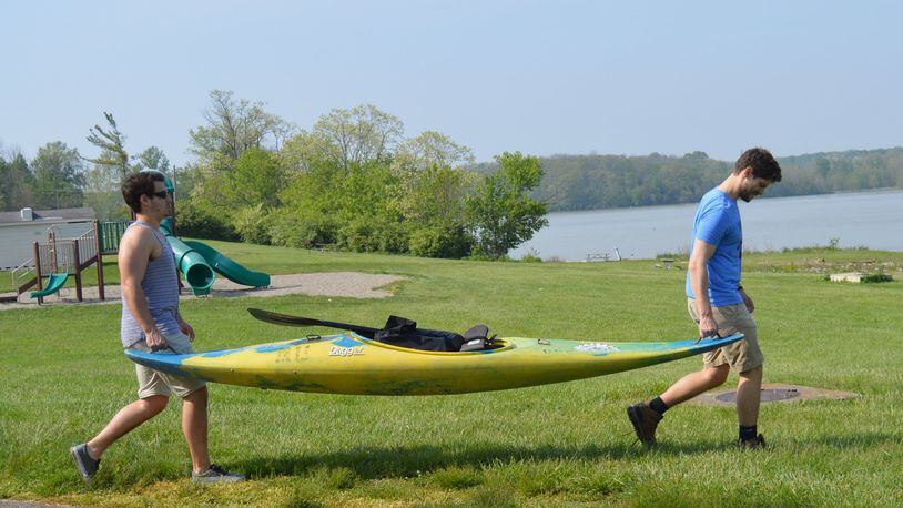 Jackson Gray (left) and Quinton Couch take a kayak to Hueston Woods Acton Lake for some practice before their 981-mile Race the River adventure. CONTRIBUTED/BOB RATTERMAN