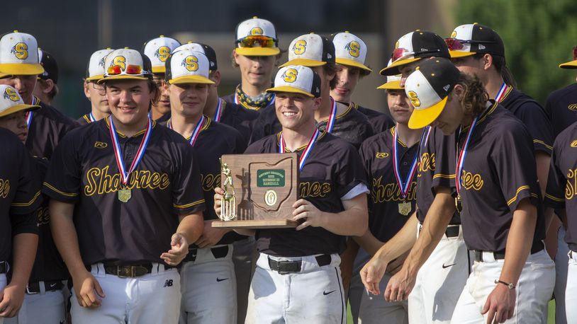 Shawnee winning pitcher Luke Myers holds the trophy after he and his teammates defeated Cincinnati Summit Country Day 4-1 to win the Braves' first district title since 2013. Jeff Gilbert/CONTRIBUTED