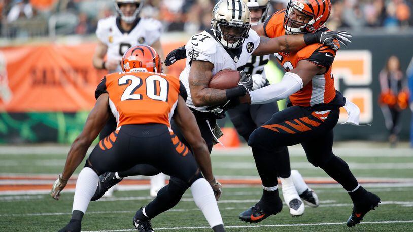 CINCINNATI, OH - NOVEMBER 11: Dwayne Washington #27 of the New Orleans Saints attempts to run the ball past Preston Brown #52 of the Cincinnati Bengals and KeiVarae Russell #20 during the fourth quarter at Paul Brown Stadium on November 11, 2018 in Cincinnati, Ohio. New Orleans defeated Cincinnati 51-14. (Photo by Joe Robbins/Getty Images)