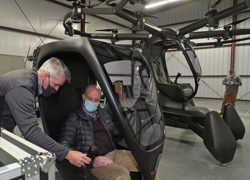 Matthew Chasen, CEO of LIFT Aircraft, instructs Tom Franzen,  Springfield Assistant City Manager, on how to fly LIFT Aircraft’s electric vertical takeoff and landing (eVTOL) vehicle at Springfield-Beckley Municipal Airport Friday. The “flying car” is the first to arrive in Ohio, and is supported by a recent $226,000 grant from JobsOhio’s Ohio Site Inventory Program in infrastructure investments at Springfield-Beckley Municipal Airport. BILL LACKEY/STAFF 